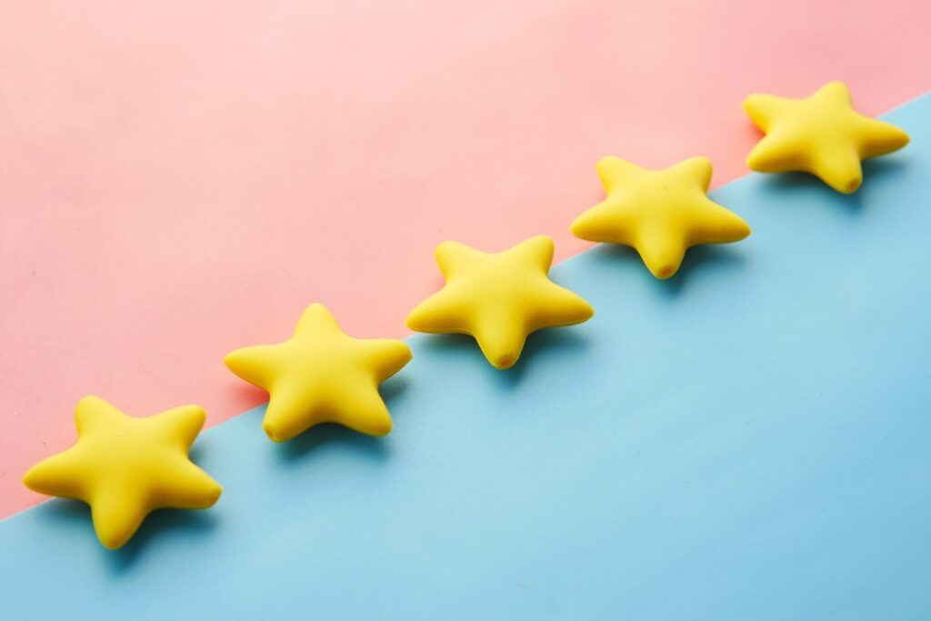 An illustration of yellow stars over a pink and blue background